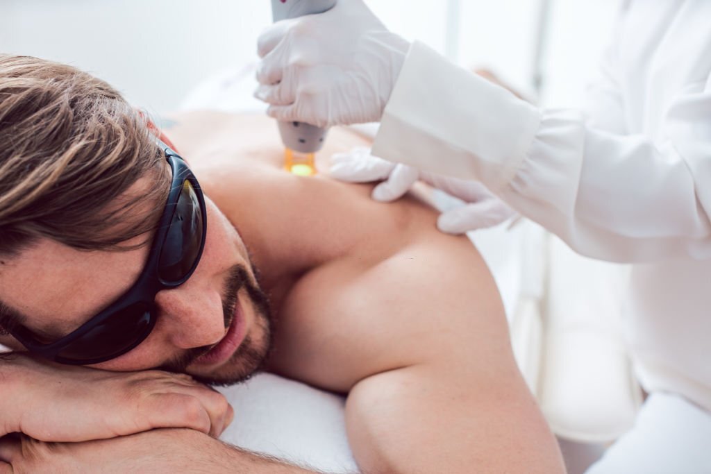 Man under treatment in a hair removal